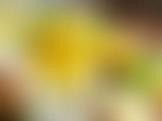 Glass mug of warm lemon ginger detox water with fresh ginger root and mint leaves.