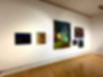 Art gallery installation with paintings of houses that watches back.