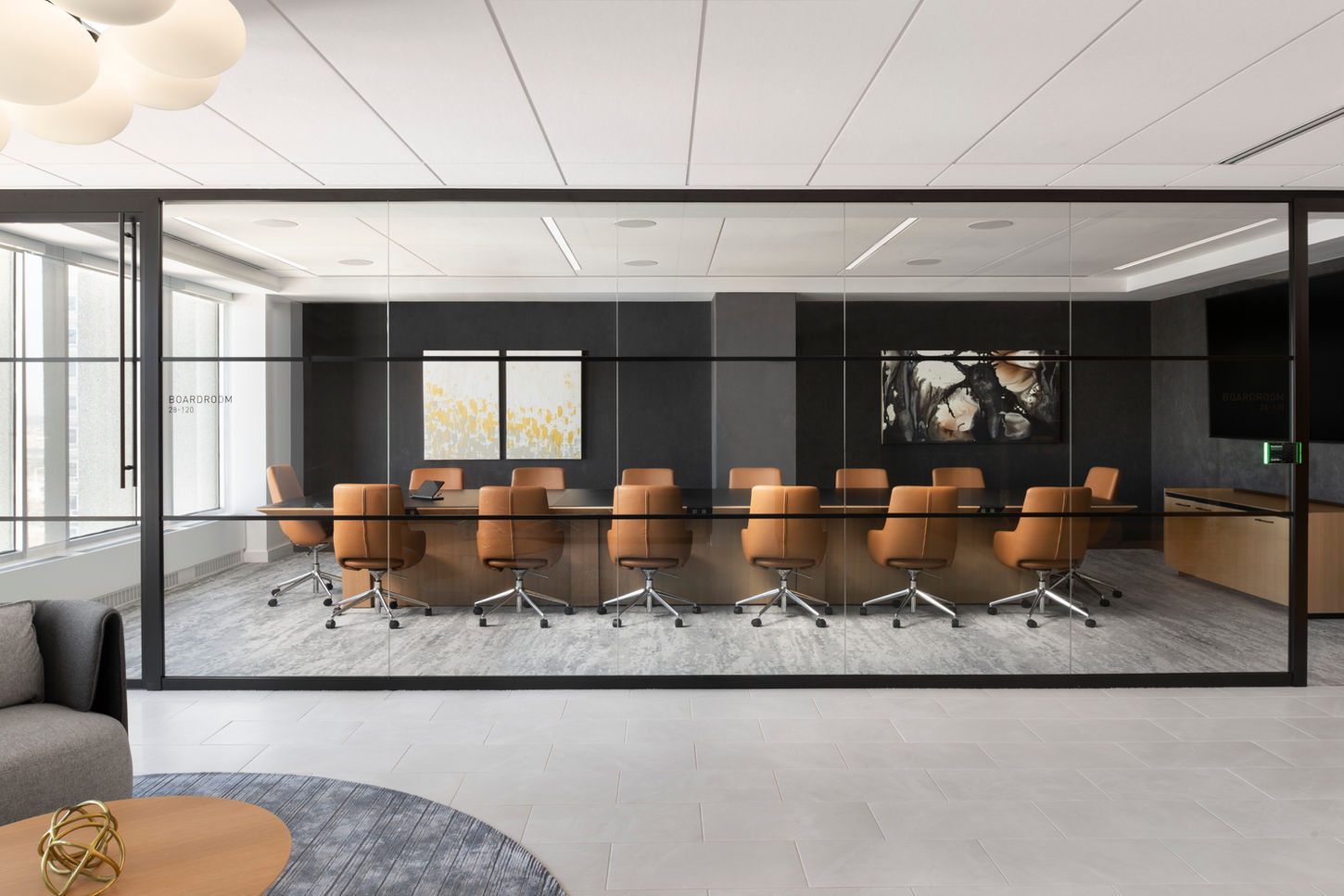 Boston commercial office photography showing executive boardroom with leather seating and downtown views