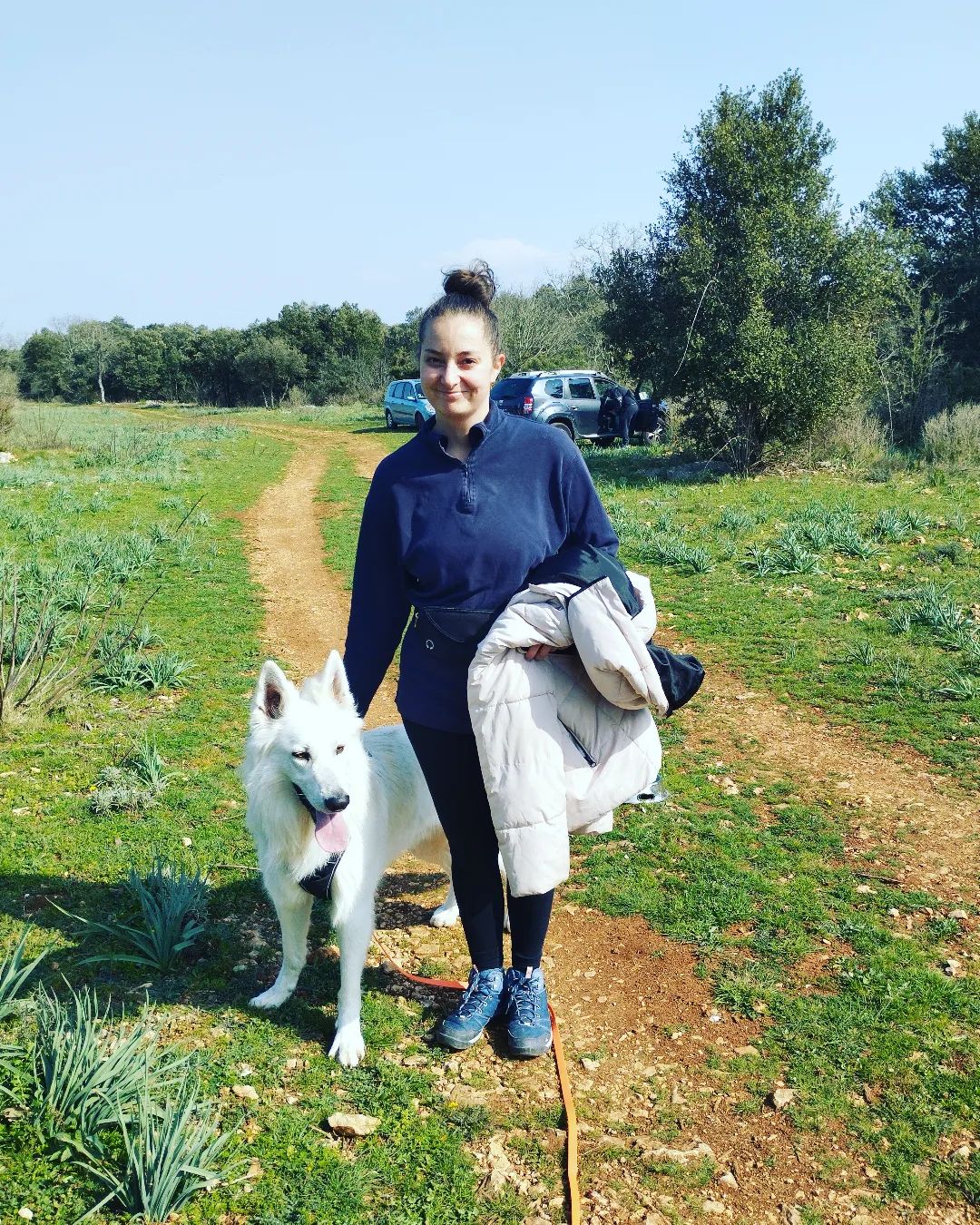 femme et son chien blanc dans la garrigue au Nord de Montpellier