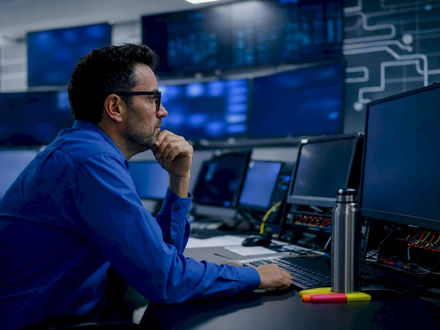 Operator monitoring smart grid in control room
