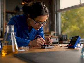 Scientist testing lithium-ion battery cell in lab