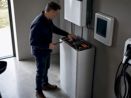 Un expert effectue le contrôle d’un système de batterie domestique installé dans le garage.