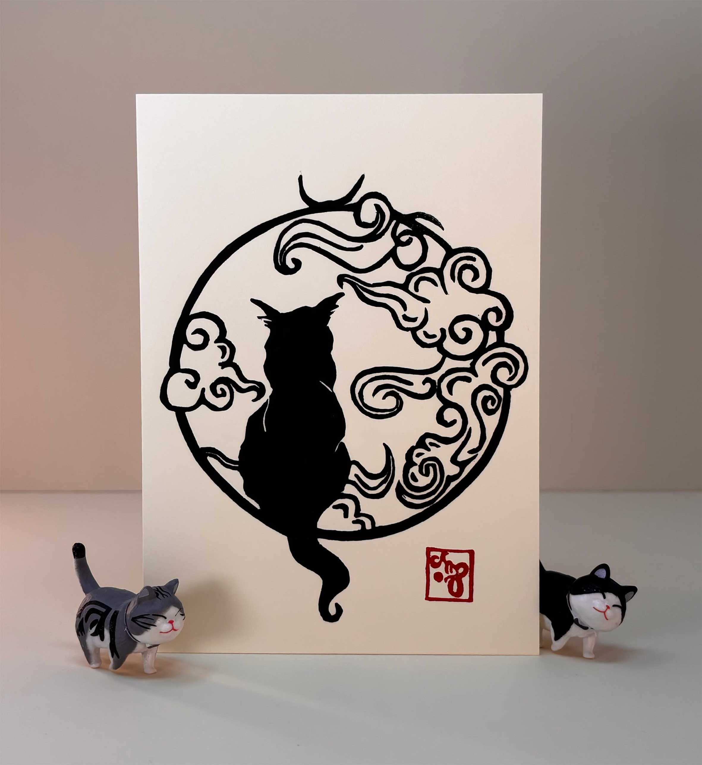 Greeting card with cat in cloud design in black ink handprinted on cream greeting card with matching envelope
