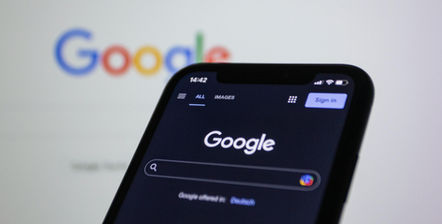 A glowing Google logo fading into smoke, symbolizing rising AI emissions and climate backtracking.