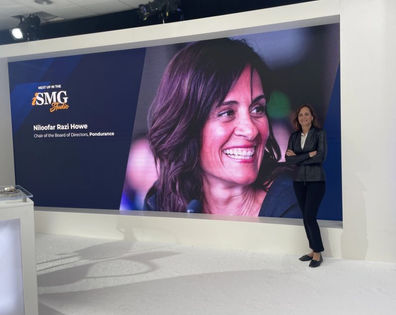 woman presenting in front of ISMG banner