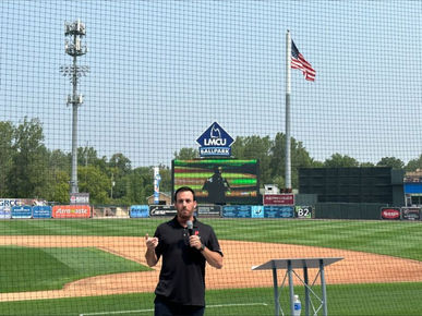 man presenting in front of field