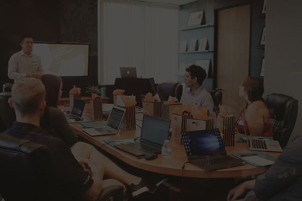 man standing in front of people sitting beside table with laptop computers_edited.jpg