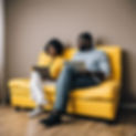 two racially ambigous people consulting on a yellow sofa.jpg