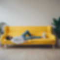 therapy session with person lying on yellow sofa.jpg