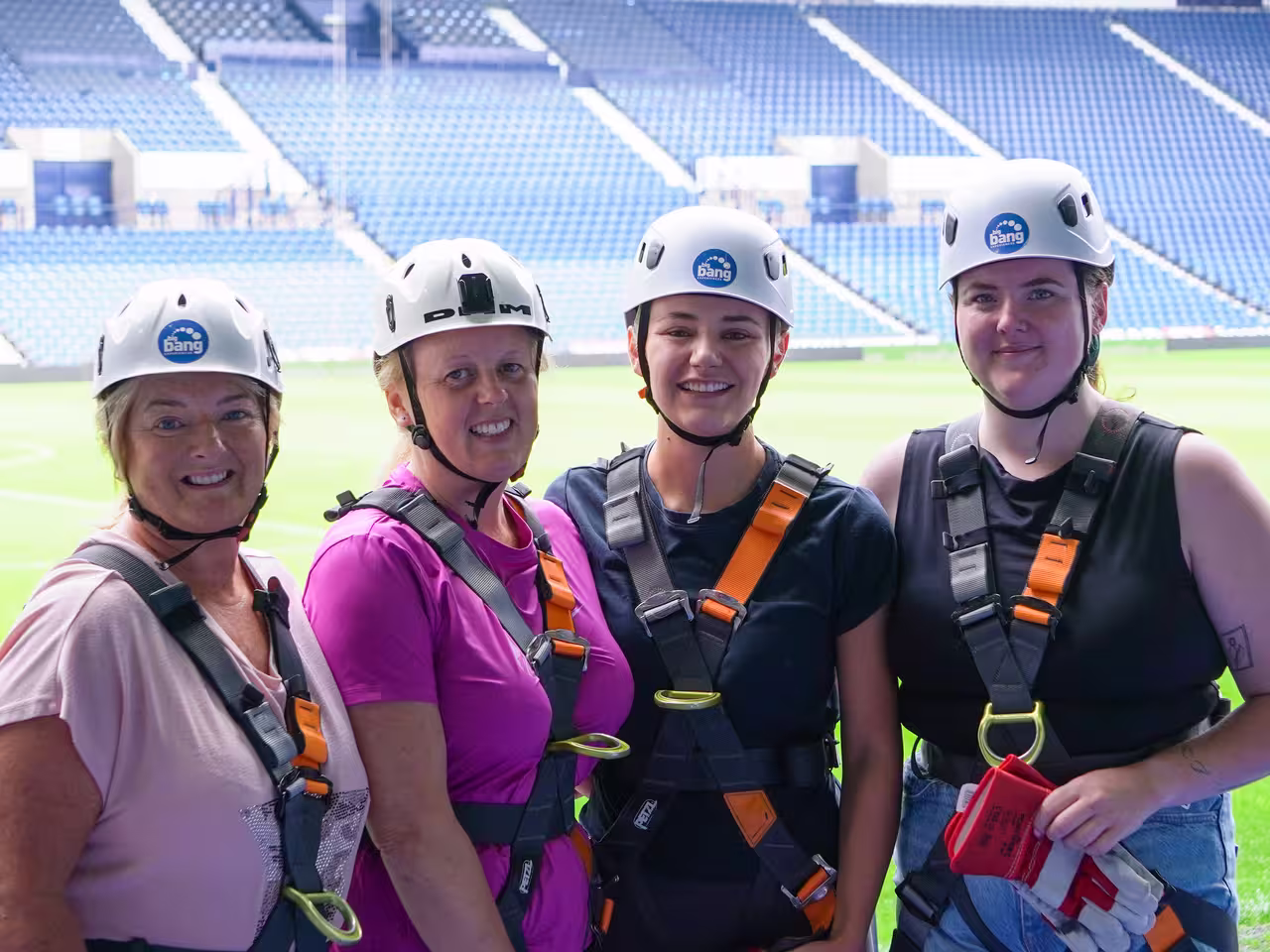 Group of fundraisers kitted up in helmets and harnesses for the abseil 