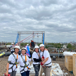 Group of abseilers in harnesses and helmets, ready to abseil from the top of Chelsea & Westminster Hospital