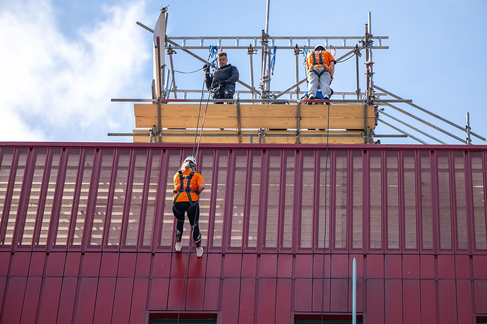 Two abseilers on the side of Barnsley Hospice as they make their descent
