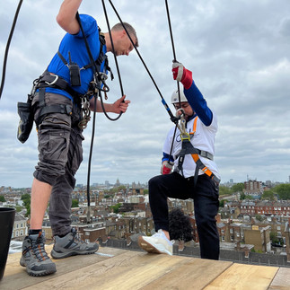 Person doing abseil off a building, being coached by the Big Bang instructor