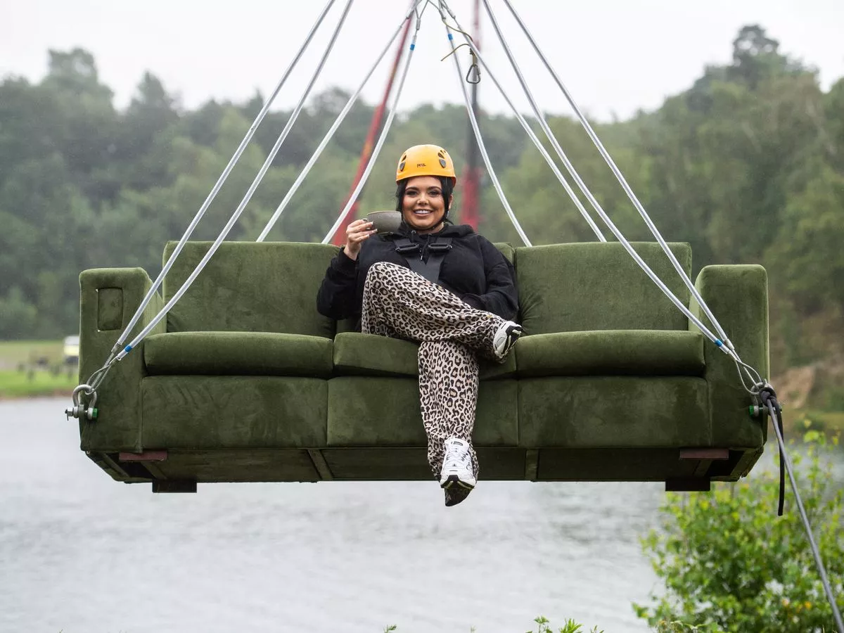 Scarlett Moffat on a sofa zip wire with a cup of tea