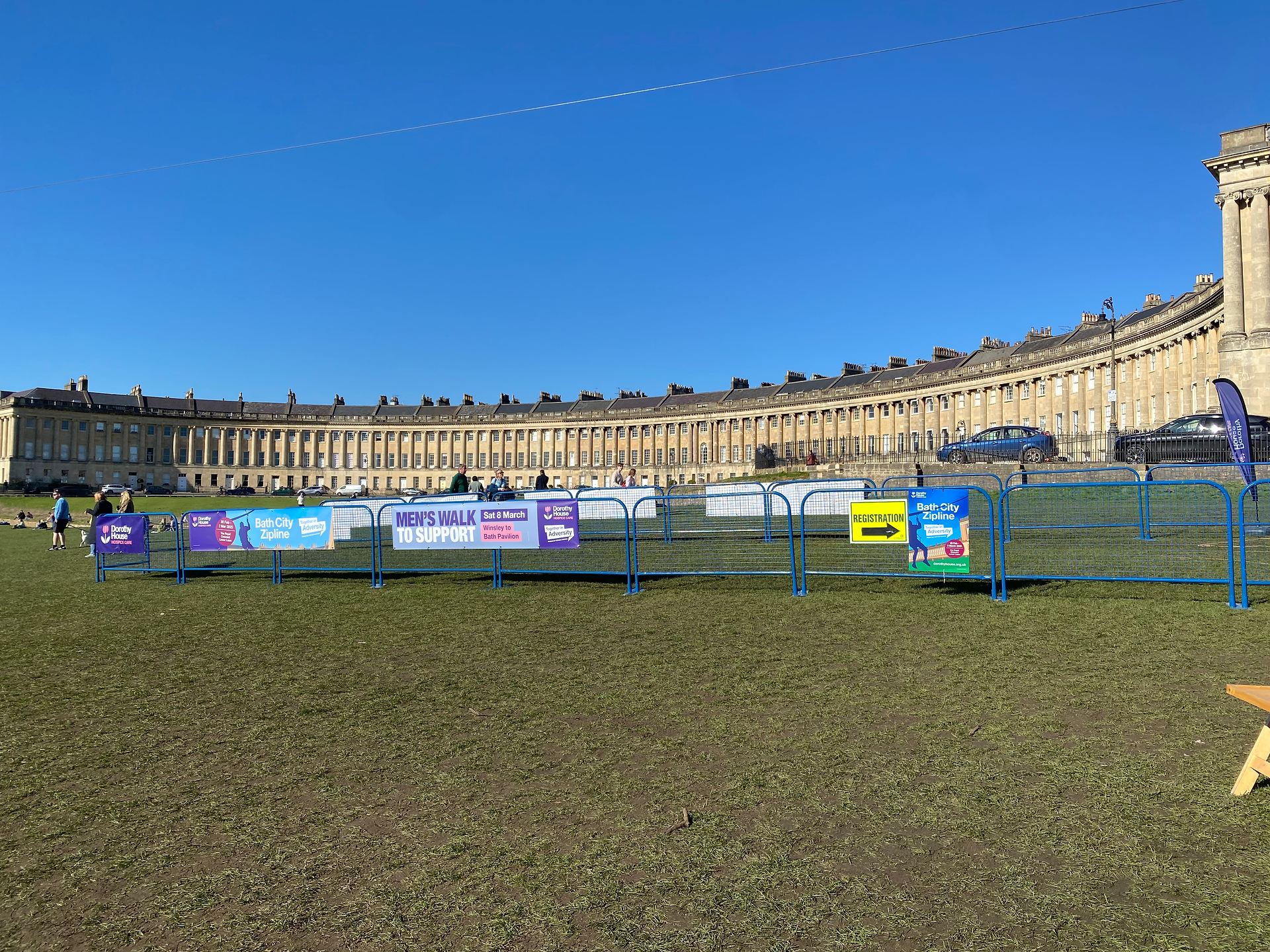 A view of the zipwire and the Royal Crescent, with advertisements for Dorothy House's upcoming fundraising events