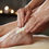 Thumbnail: Close-up of a woman's hands applying creamy, Lavender Body Butter to the top of her foot and ankle.