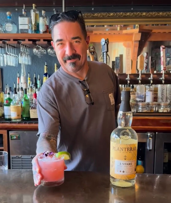 Bartender serving a craft cocktail