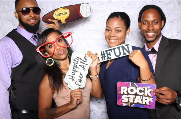People posing with fun props at a party.
