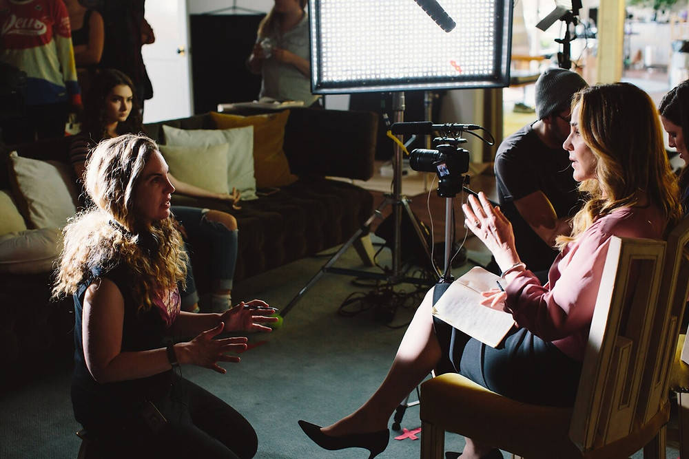 Kate Hackett talking to one of the adult women in the film