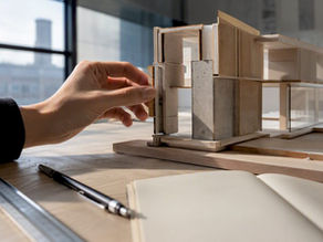 Hand adjusting load-bearing wall on architectural model