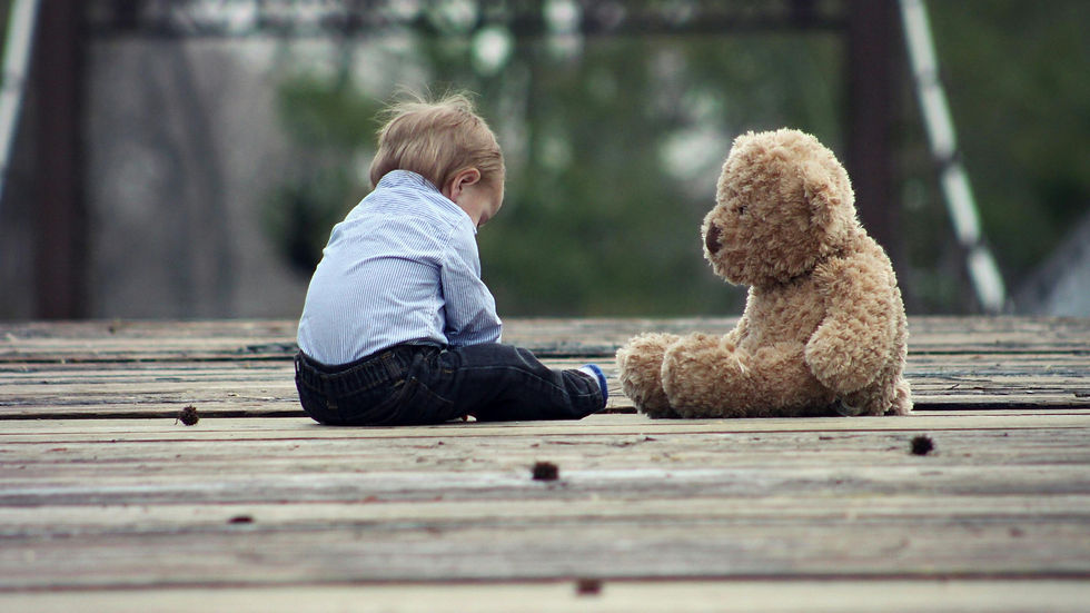 little boy playing with bear