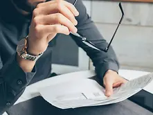 divorcing man reviewing financial assets and debts for judgment on case.webp