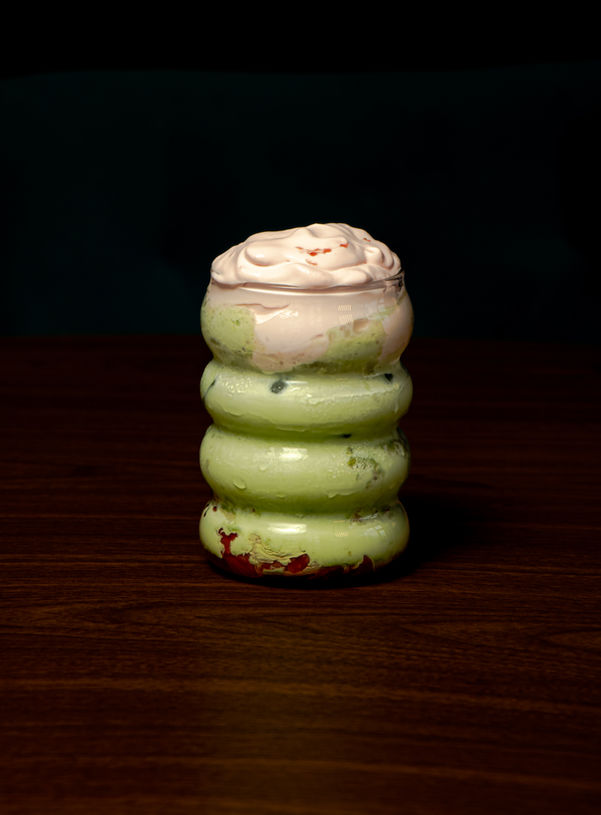 Iced matcha latte served in a clear cup with layered green tea and creamy milk, over ice, at Café Karak