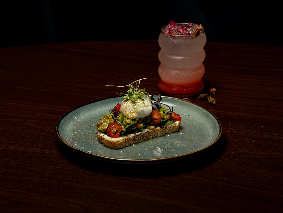 Cafe Karak's Avocado Toast with Creamy avocado with jalapeños and a touch of honey glaze over sourdough. Sweet heat on toast.