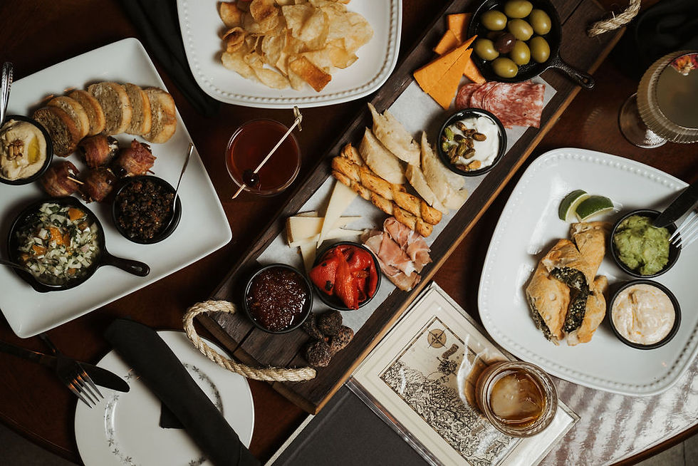 Flat lay of assorted share plates served at Romero’s Lounge & Cocktail Bar