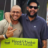 Equipe do Honestinho Smash Burger com Emicida em São Paulo, mostrando a marca em contexto urbano e cultural