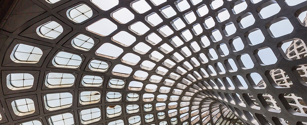 modernist concrete architecture, swirling upwards as a grid of holes against the sky