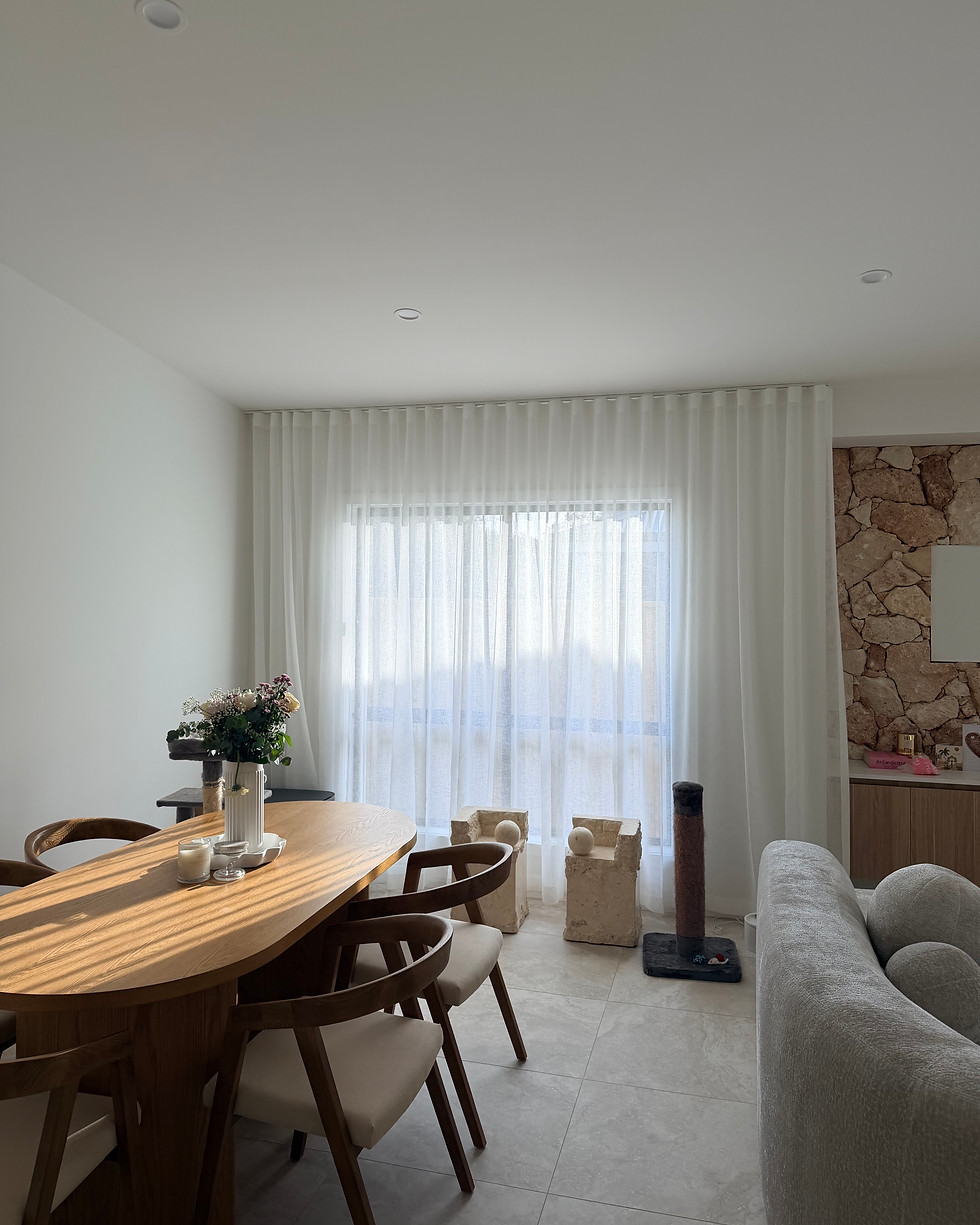 Sheer white curtains in a dining room by a curtain and blind studio