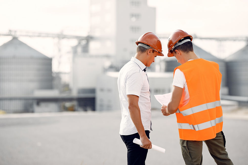 engineers-in-helmets-standing-by-the-factory.jpg