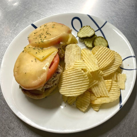 Tuna Melt served with pickles and chips