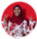 Image of a female student in a head scarf smiling into the distance, holding up two peace signs with her hands.