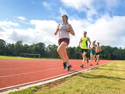 Trip Garner is running on an outdoor track with his three children on a beautiful spring day.