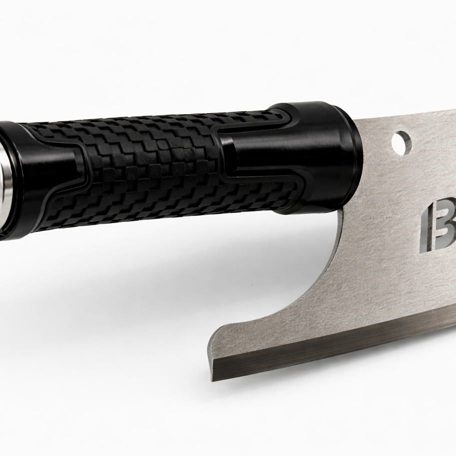 Close-up of a black textured knife handle and metal "BAD" blade.