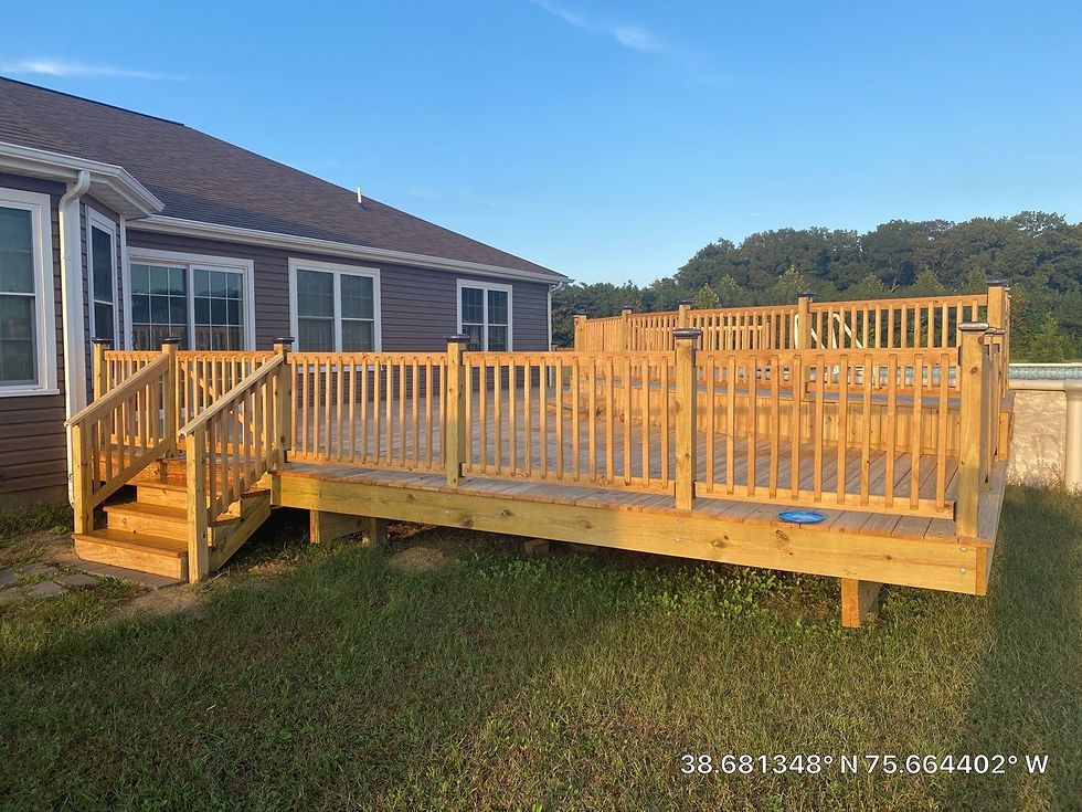 Newly constructed wood deck with railings and steps; backyard view