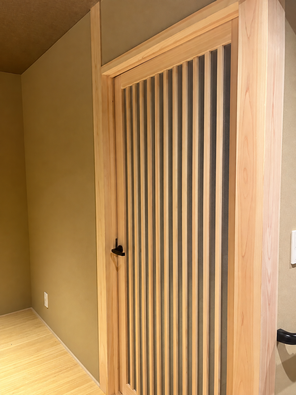 縦格子の木製建具と周囲の木枠