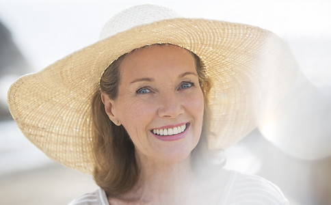 Woman wearing straw hat on beach