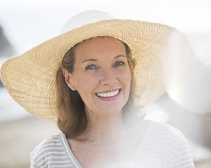 Older woman wearing straw hat on beach