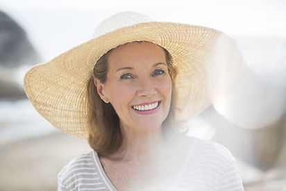 Older woman wearing straw hat on beach