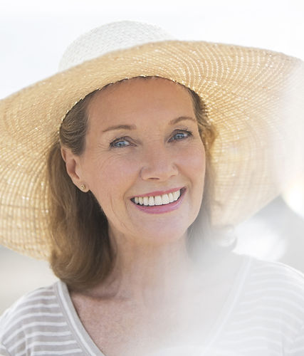 Older woman wearing straw hat on beach