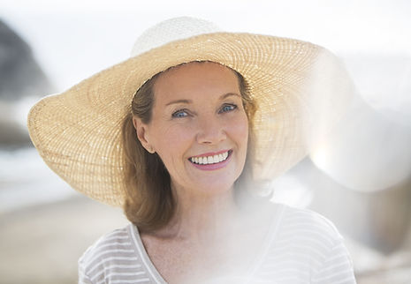 Older woman wearing straw hat on beach