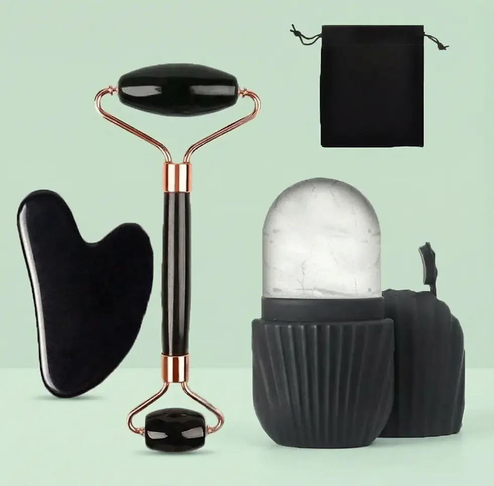 Black jade roller, gua sha, ice facial roller kit on green background.