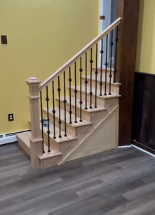 Oak interior staircase with wrought iron balusters, wood newel post and new plank flooring