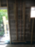 Timber stud wall with services exposed ahead of boarding