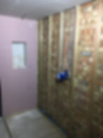 Boarded and painted wall with a recess marked out for a shower niche