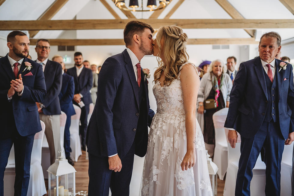 the bride and grooms first kiss at Cottesmore wedding ceremony, Cottesmore golf club wedding